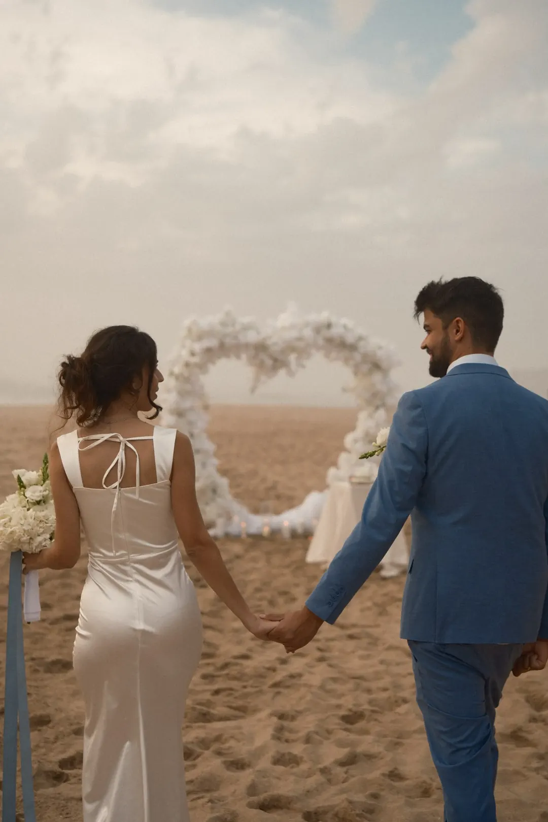 The newlyweds walking together along the beach