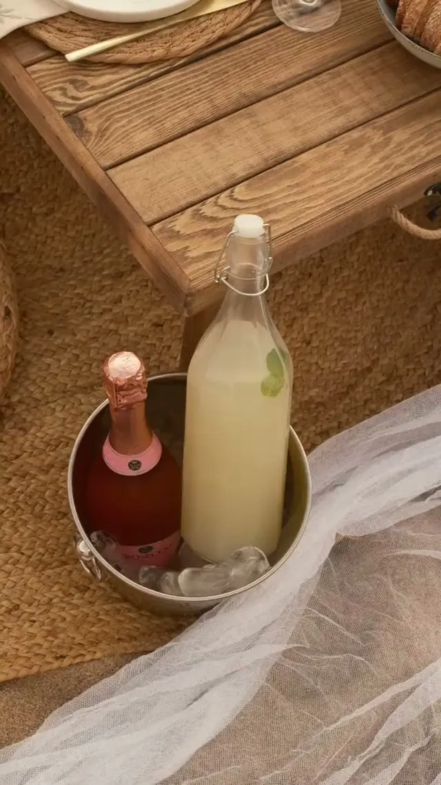 Bottles on ice beside a picnic table